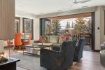 Enjoy stunning ski run views from the living room, featuring a brand new accordion patio door for effortless outdoor access